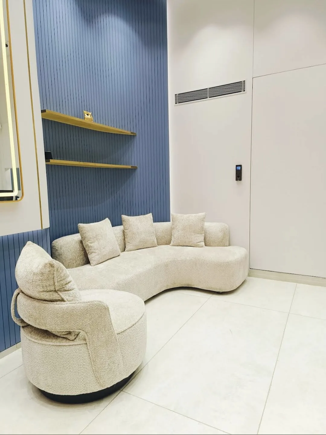A curved cream sofa in the showroom's seating corner